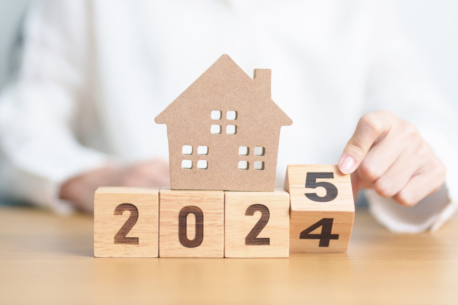 2024 end year to Happy New Year 2025 with house model. real estate, Home loan and mortgage, tax, investment, financial, savings and New Year Resolution concepts